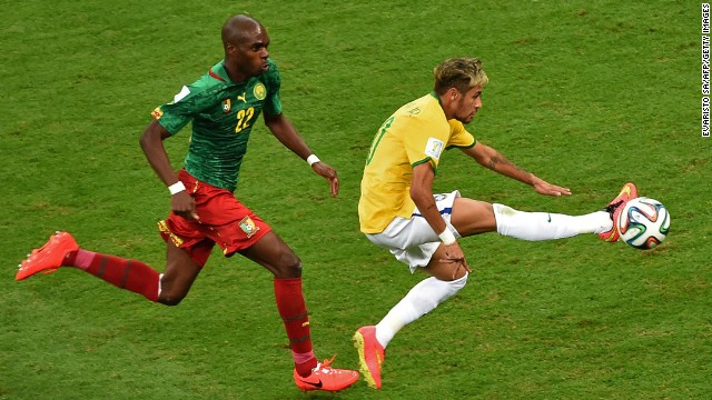 Cameroon defender Allan Nyom, left, and Brazil forward Neymar compete for the ball.