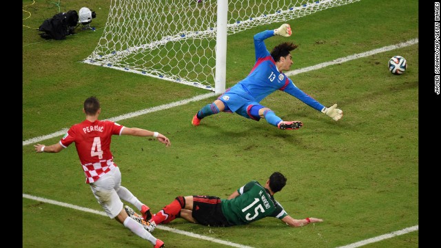 Goalkeeper Guillermo Ochoa of Mexico fails to stop Croatian midfielder Ivan Perisic from scoring on Monday, June 23, in Recife, Brazil. Mexico won 3-1. 