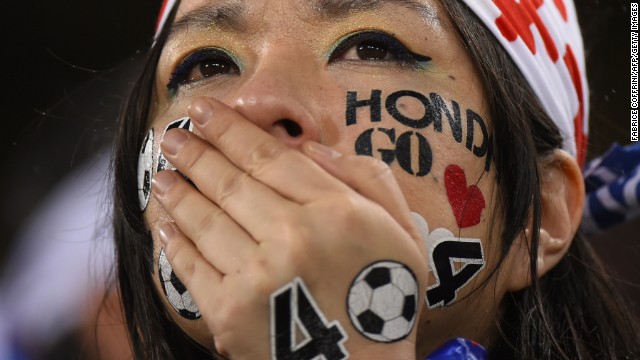 A Japan supporter cries after her team tied Greece in group play on June 19.