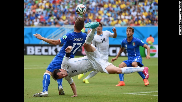 Diego Godin of Uruguay and Ciro Immobile of Italy compete for the ball. 