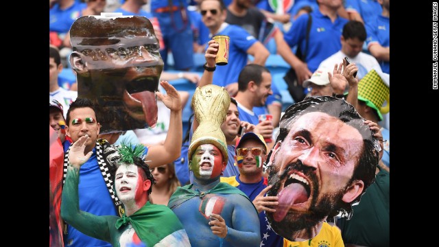 Italy fans hold up cardboard cutouts of forward Mario Balotelli, left, and midfielder Andrea Pirlo. 