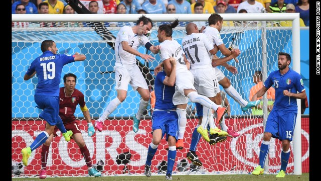 Uruguay defender Diego Godin, third left, scores. 