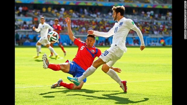 Adam Lallana of England is challenged by Oscar Duarte of Costa Rica during a match at Estadio Mineirao in Belo Horizonte. The game ended in a 0-0 draw.