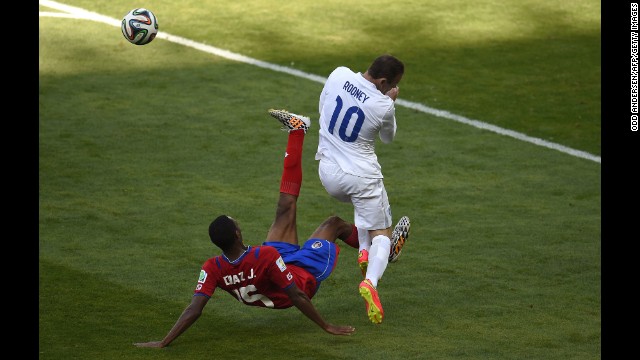 England forward Wayne Rooney, right, reacts after a challenge from Costa Rica defender Junior Diaz. 