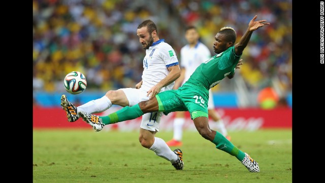 Dimitris Salpingidis of Greece, left, and Die Serey of the Ivory Coast compete for the ball.
