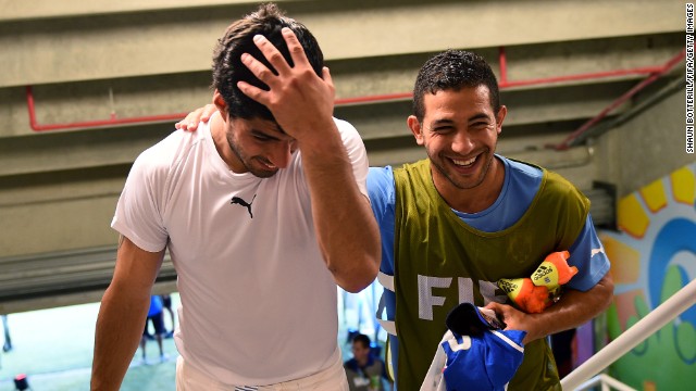 Suarez, left, celebrates the 1-0 win against Italy with his teammate Walter Gargano in the tunnel after the controversial match at Estadio das Dunas.