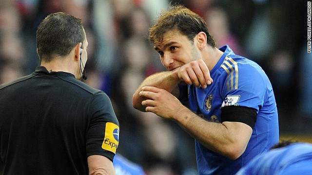 Ivanovic demonstrates the bite he received from Suarez to a referee.