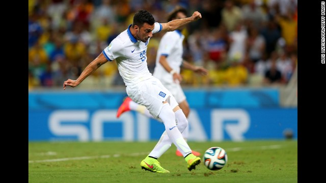 Andreas Samaris of Greece scores against the Ivory Coast.