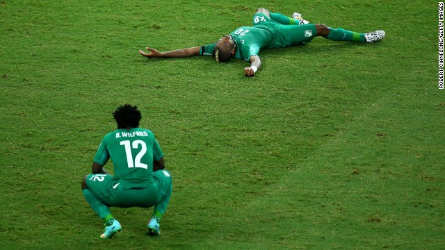 A dejected Wilfried Bony, left, and Die Serey of the Ivory Coast react after being defeated by Greece 2-1 during a World Cup match on Tuesday, June 24, in Fortaleza, Brazil.