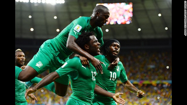 Wilfried Bony of the Ivory Coast celebrates scoring his team's first goal with Yaya Toure, left, and Gervinho.