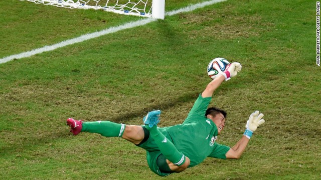 Japan's goalkeeper Eiji Kawashima fails to stop Colombia from scoring.