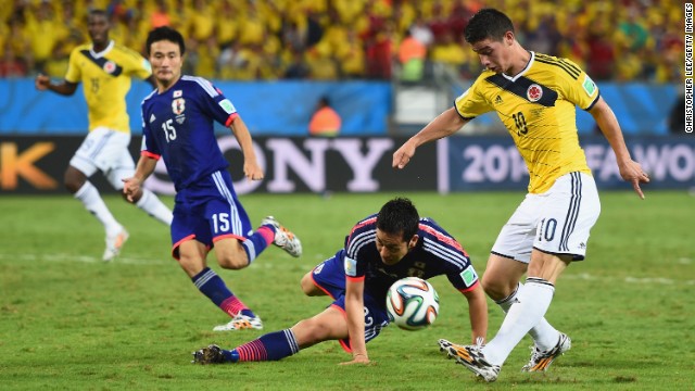 James Rodriguez of Colombia shoots and scores his team's fourth goal against Japan on June 24 in Cuiaba, Brazil. Colombia won 4-1.