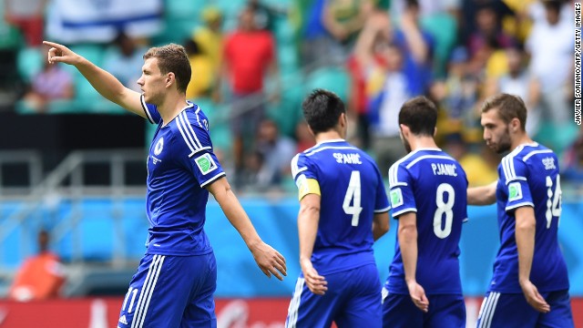 Bosnia-Herzegovina forward Edin Dzeko, left, celebrates scoring his team's first goal against Iran.