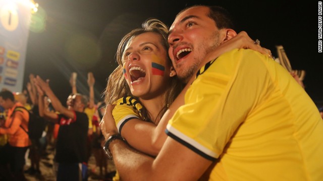 Colombia supporters at the FIFA Fan Fest on Copacabana Beach embrace and celebrate a World Cup win over Japan on Tuesday, June 24.