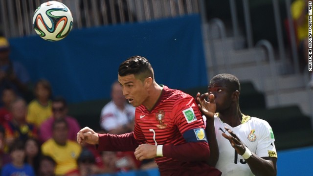 Portugal forward Cristiano Ronaldo and Ghana defender Jonathan Mensah vie for the ball.