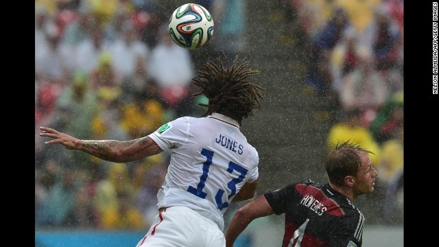 Jermaine Jones of the United States and Benedikt Hoewedes of Germany jump for the ball during their game in Recife.