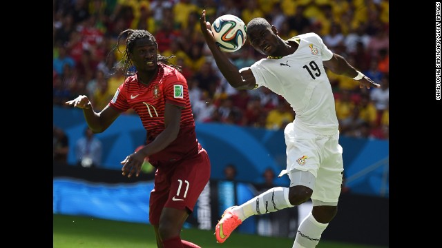 Eder of Portugal and Jonathan Mensah of Ghana jump for the ball.
