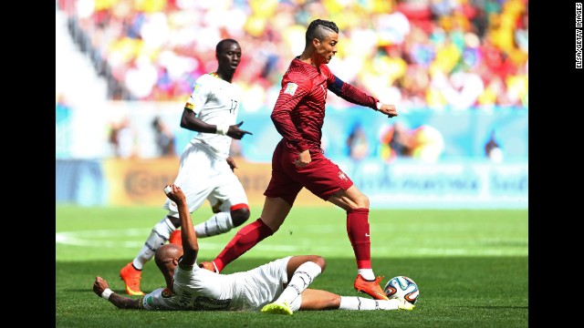 Andre Ayew of Ghana tackles Cristiano Ronaldo of Portugal.