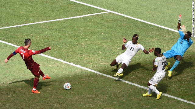 Portugal's Christiano Ronaldo, left, strikes the ball to score a goal against Ghana.