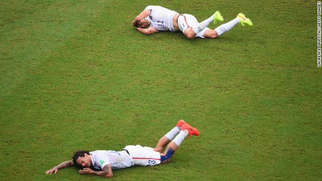 Jermaine Jones, front, of the United States and teammate Alejandro Bedoya lie on the field after colliding during a match against Germany.