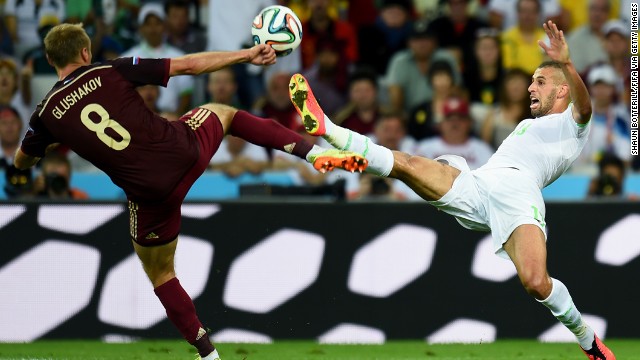 Islam Slimani of Algeria and Denis Glushakov of Russia compete for the ball.