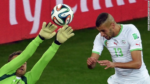 Algeria forward Islam Slimani, right, heads the ball to score a goal past Russia's goalkeeper Igor Akinfeev during a World Cup match at the Baixada Arena in Curitiba, Brazil. 