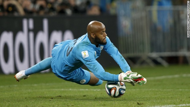 Algeria's goalkeeper Rais M'bohli dives for the ball.