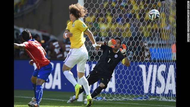 Chile's goalkeeper, Claudio Bravo, can't stop the ball from going in for a Brazil goal. The goal was initially awarded to David Luiz, center, but it was later determined to be an own goal by Chile's Gonzalo Jara.