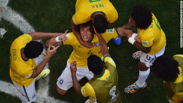 Brazil's defender David Luiz, center, celebrates with teammates after scoring a goal.