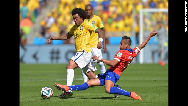 Alexis Sanchez of Chile tackles Marcelo of Brazil.