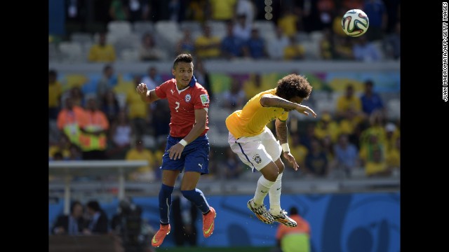 Chile's Alexis Sanchez, left, and Brazil's Marcelo jump for the ball.