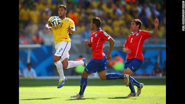 Hulk of Brazil handles the ball before scoring a goal that was taken back after being ruled a hand ball foul. The goal would have given the Brazilian team a lead on Chile with a score of 2-1.