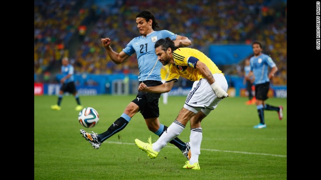 Edinson Cavani of Uruguay, left, challenges Mario Yepes of Colombia.