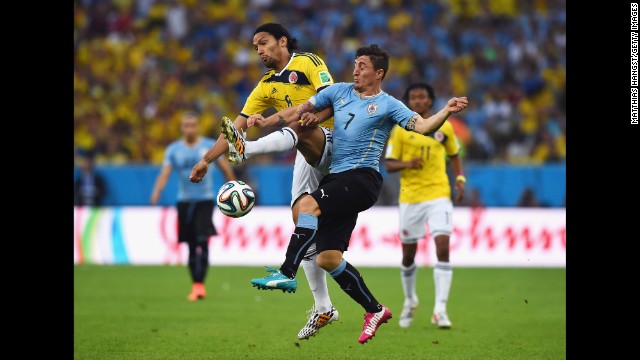 Abel Aguilar of Colombia and Cristian Rodriguez of Uruguay compete for the ball.