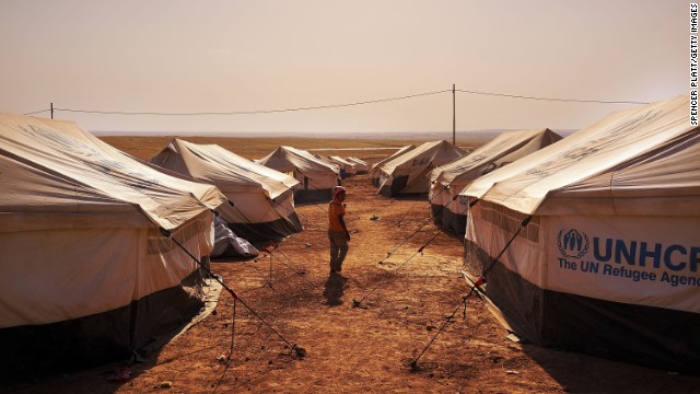 An Iraqi child walks through a displacement camp Saturday, June 28, in Khazair, Iraq.