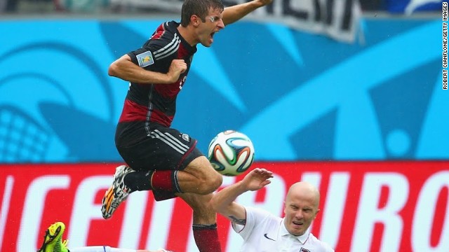 Michael Bradley battles for the ball with Germany's match-winner Thomas Muller.