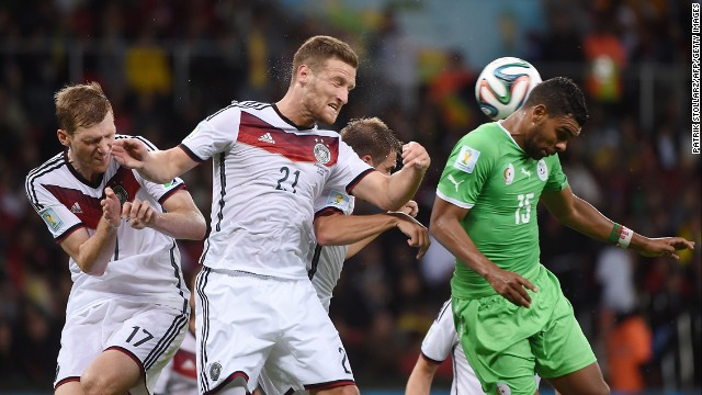 German defenders Per Mertesacker, left, and Shkodran Mustafi, second from left, take on Algeria's El Arabi Soudani.