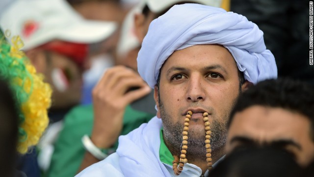 An Algeria fan awaits the kickoff of the match.