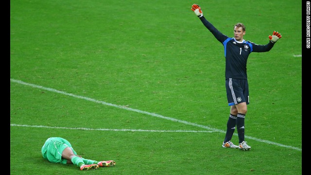 Islam Slimani of Algeria lies on the pitch next to goalkeeper Manuel Neuer of Germany during a World Cup match Monday, June 30, in Porto Alegre, Brazil. Although Algeria had a late goal, Germany still advanced to the quarterfinals with a 2-1 victory.
