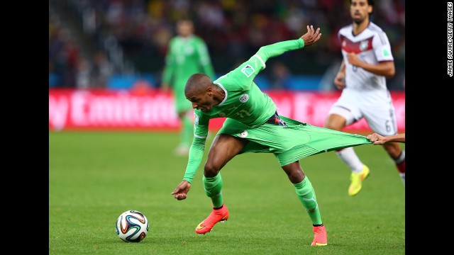 Yacine Brahimi of Algeria has his shorts pulled by Philipp Lahm of Germany.