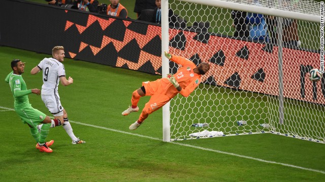 Andre Schuerrle, center, scores a backheel goal in extra time to give Germany a 1-0 lead over Algeria.