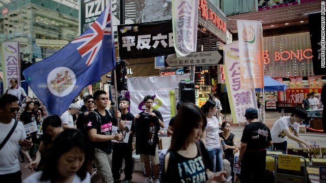 A man carries a Hong Kong colonial flag as part of the commemoration of China's 1989 Tiananmen Square military crackdown on pro-democracy protesters, in Hong Kong on June 4, 2014. 