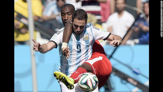 Djourou, back, and Argentine forward Gonzalo Higuain compete for the ball.