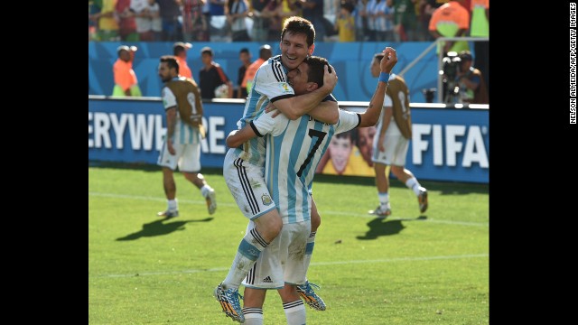 Argentina players Lionel Messi, left, and Angel Di Maria celebrate after Di Maria scored the winning goal in extra time to beat Switzerland 1-0 and advance to the World Cup quarterfinals.