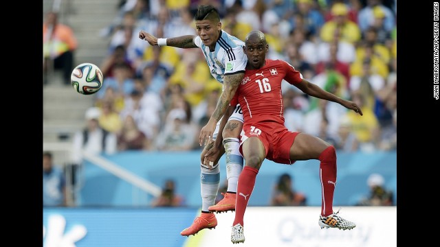 Swiss midfielder Gelson Fernandes, right, and Rojo compete for the ball.