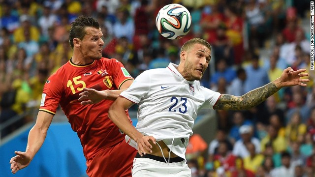 Belgium defender Daniel Van Buyten, left, fights for the ball against U.S. defender Fabian Johnson.