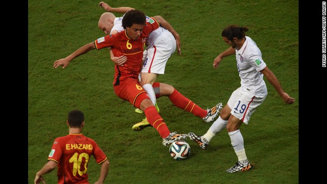 U.S. midfielders Michael Bradley, second from right, and Graham Zusi, right, compete against Witsel.