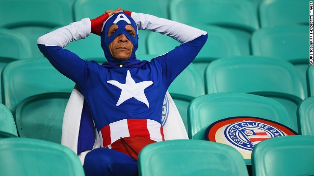 A fan dressed as Captain America looks on after Belgium's victory.