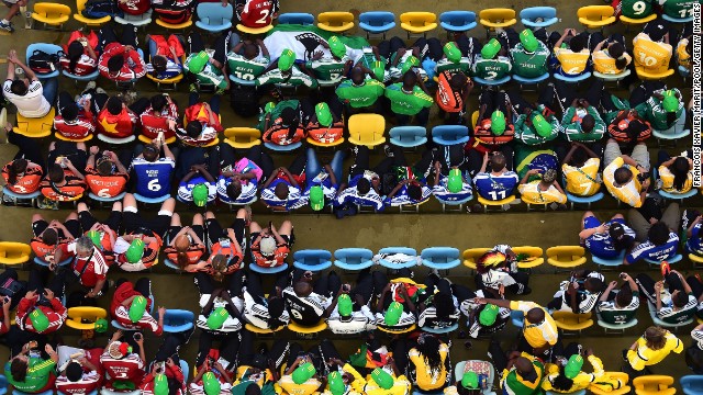 Fans sit in the Maracana stadium before the match.