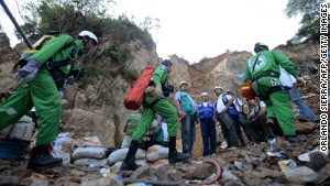 Rescuers take part in the operation to free three laborers trapped in a collapsed mine.